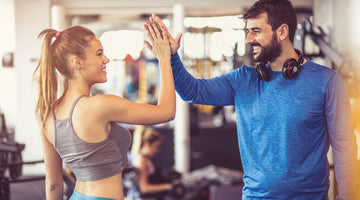 healthy man and woman high five for taking nitric oxide supplements